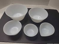 All five white milk glass bowls displayed, showing sizes and shapes