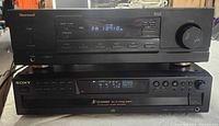 Front view of Sherwood RX-4105 receiver stacked on Sony CDP-CE375 CD player showing displays and controls