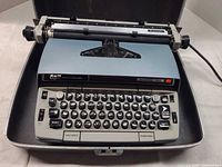 Full view of Smith-Corona Electra 220 in open case with keyboard and carriage visible