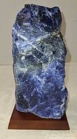 Front view of sodalite specimen on wood base showing overall form and color