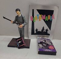 Front view of figurine, booklet, VHS