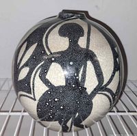 Front view of spherical vase showing silhouette figure and crackle glaze