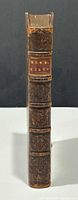 spine view showing leather binding, raised bands and red title label