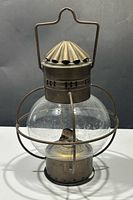 Front view of brass onion oil lantern showing full shape and handle