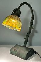 Full view of lamp showing branch stem, log base, and glass shade
