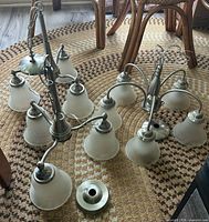 All three brushed nickel chandeliers with shades and canopies displayed