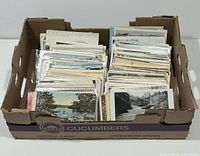 Box filled with organized rows of postcards