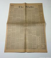 Entire unfolded front page showing full newspaper