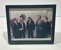 Full view of framed photograph showing five Presidents in black shadow box frame
