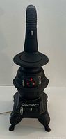 Full view of ceramic pot belly stove lamp showing overall form and power cord