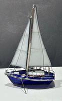 Full view of stained glass sailboat showing hull, sails, and stand