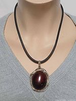 Front view of pendant worn on mannequin showing overall appearance