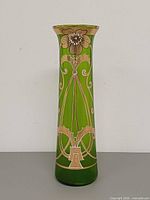 front view of green glass vase showing floral enamel decoration