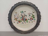 Full view of charger showing painted scene and metal rim