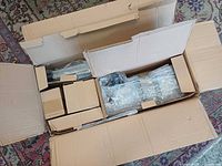 Open box showing full telescope kit packed in smaller boxes and bubble wrap