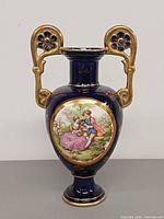 Front view showing romantic scene, cobalt body, gold gilt handles