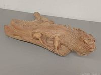 Perspective view of full wood iguana showing head, limbs and base