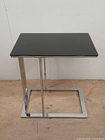 front view of chrome frame and black glass top