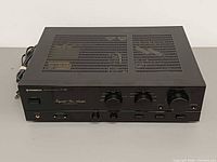 Front angled view of Pioneer A-447 amplifier showing overall condition and attached power cord
