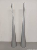 Front view of both tall candle holders standing upright