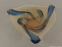 Top view showing tri-corner form, amber glass and blue ribbons