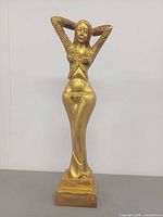 Front view of gold painted carved wooden woman statue