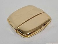 Top view of closed gold tone metal mirror case