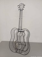 Front view of guitar-shaped metal CD rack
