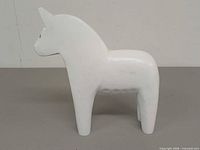 left side view of white wooden Dala horse