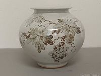 Front view of signed Japanese ceramic vase showing floral design