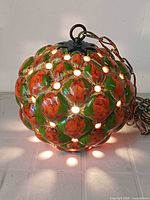 Pendant illuminated to show light through perforations