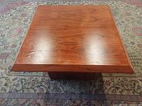 top view of square teak coffee table showing grain and beveled edge
