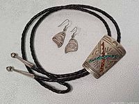 Full view of bolo tie, earrings, and cord tips