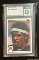 Front of graded Deion Sanders 1990 Upper Deck rookie card showing CSG 8.5 label