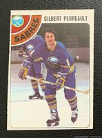 Front view of Gilbert Perreault O-Pee-Chee hockey card showing player image and team graphics