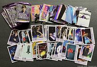 Multiple opened trading card wrappers, stacks of assorted Justin Bieber cards laid out for view