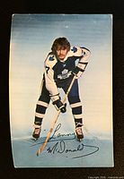 Front of vintage Lanny McDonald Maple Leafs postcard showing player image and facsimile signature