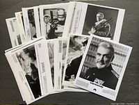 Stack showing multiple black-and-white 8x10 publicity photos including RoboCop and Sean Connery portrait