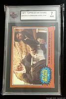 Front of KSA-slabbed card showing photo, label with series, card number and grade