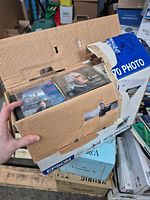 Overview of open cardboard box showing multiple classical CDs inside