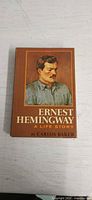 Front cover showing title, author, portrait of Hemingway