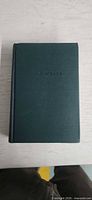 Front cover showing embossed author name on green cloth