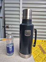 Full view of flask beside water bottle for scale