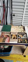 Front covers of six hardcover art books on table