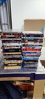 Front view of two stacks of DVDs and Blu-rays on table