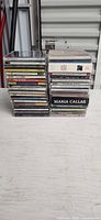 Front view of two stacks of jewel case CDs on table