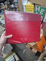 Front of red presentation folder with title
