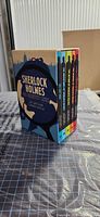 Box set standing, showing spines of all five volumes and slipcase artwork