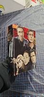 Front of illustrated slipcase with various character portraits