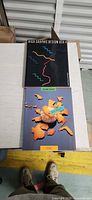 Front covers of both hardcover graphic design books